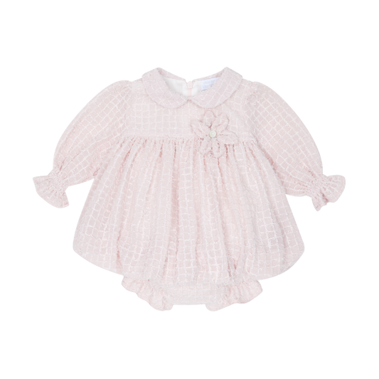 Pink baby dress with ruffled sleeves on a white background