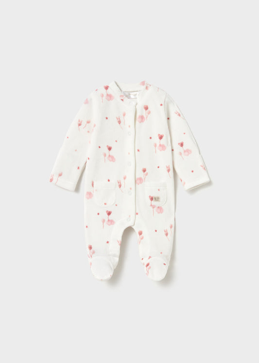 A baby long-sleeve footed sleeper in white with a pink heart and balloon pattern, shown flat on a light gray background.
