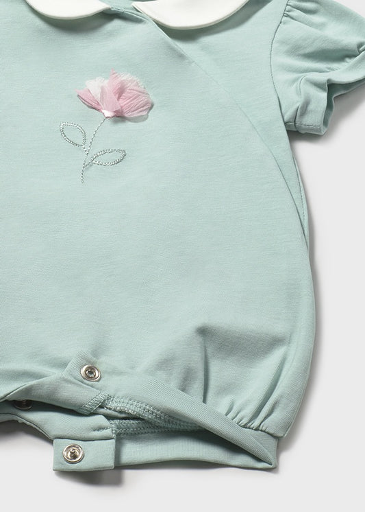 Light blue baby romper with pink flower design on a white background