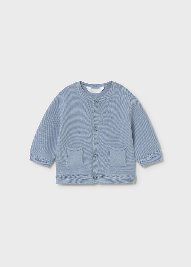 Blue knitted cardigan on a light gray background