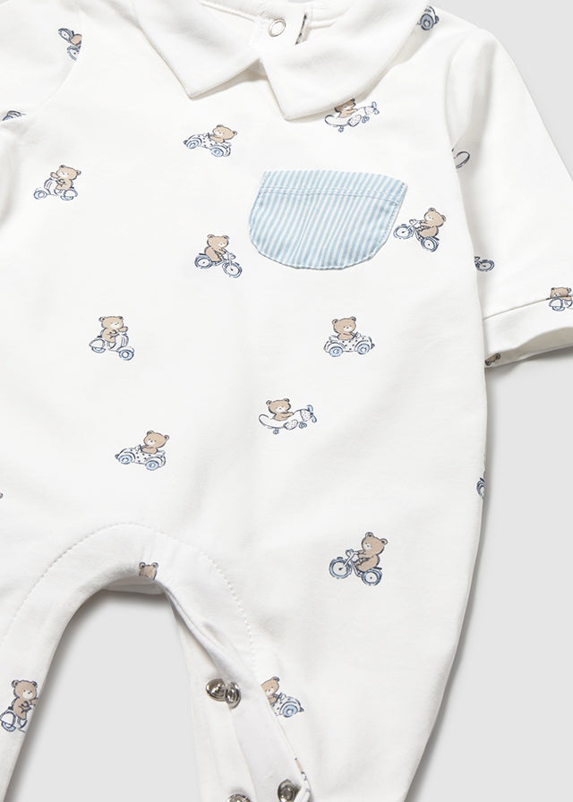 Baby outfit with teddy bear and bicycle pattern on a white background