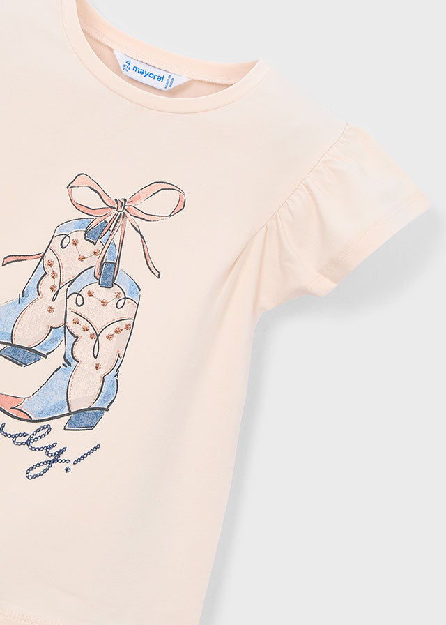 Pink t-shirt with graphic design on a light gray background
