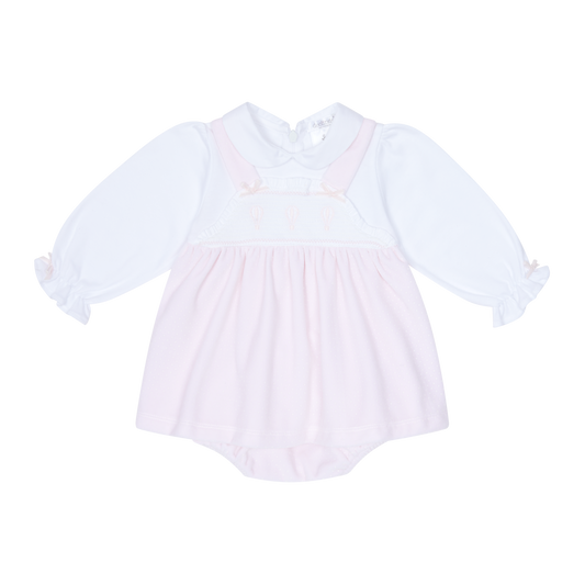 White baby dress with long sleeves on a white background
