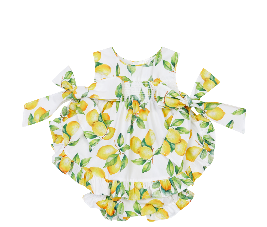 Baby romper with lemon print on a white background
