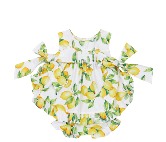 Baby romper with lemon print on a white background