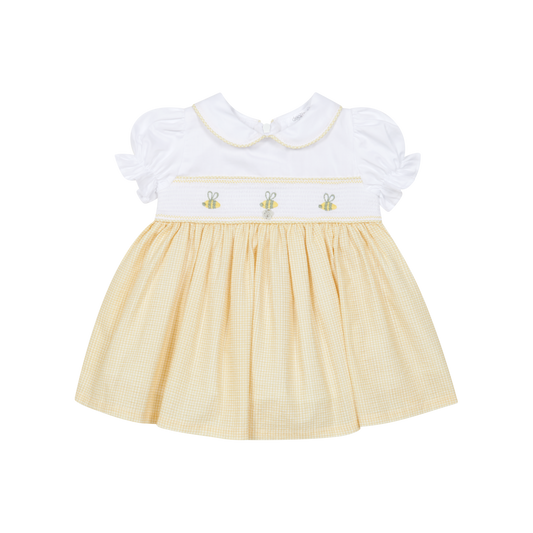 Yellow dress with white ruffled collar on a white background