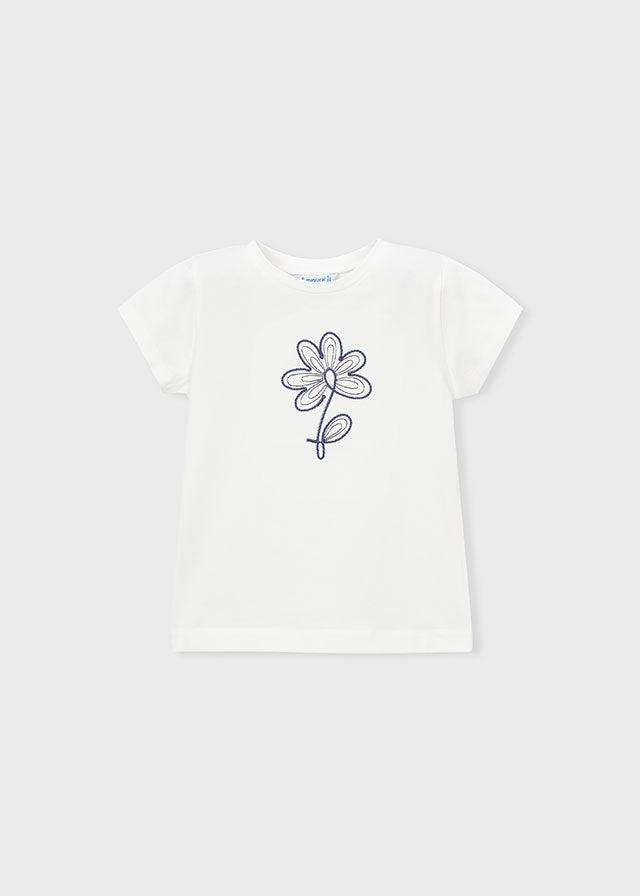 White t-shirt with a black flower design on a white background